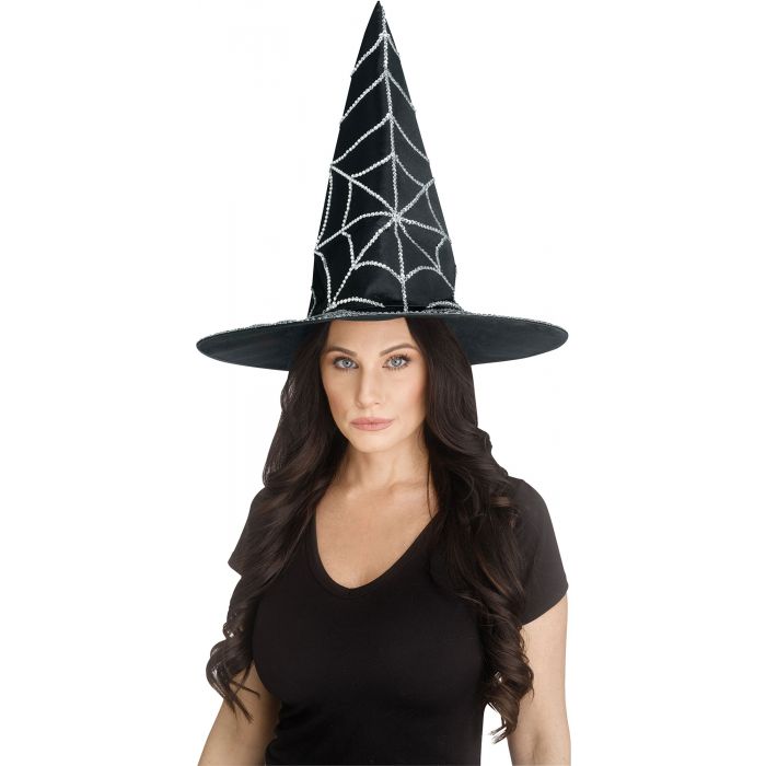 Woman wearing a black witch hat with a spider web design on a white background