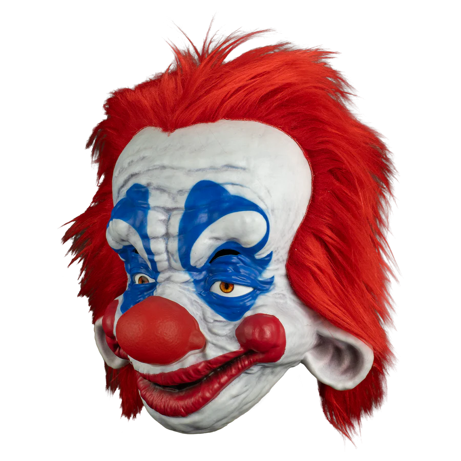 Clown mask with red hair, white face, and blue face paint on a white background
