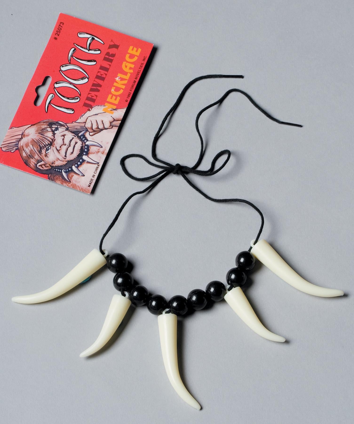 Bead and faux sabre tooth tie necklace